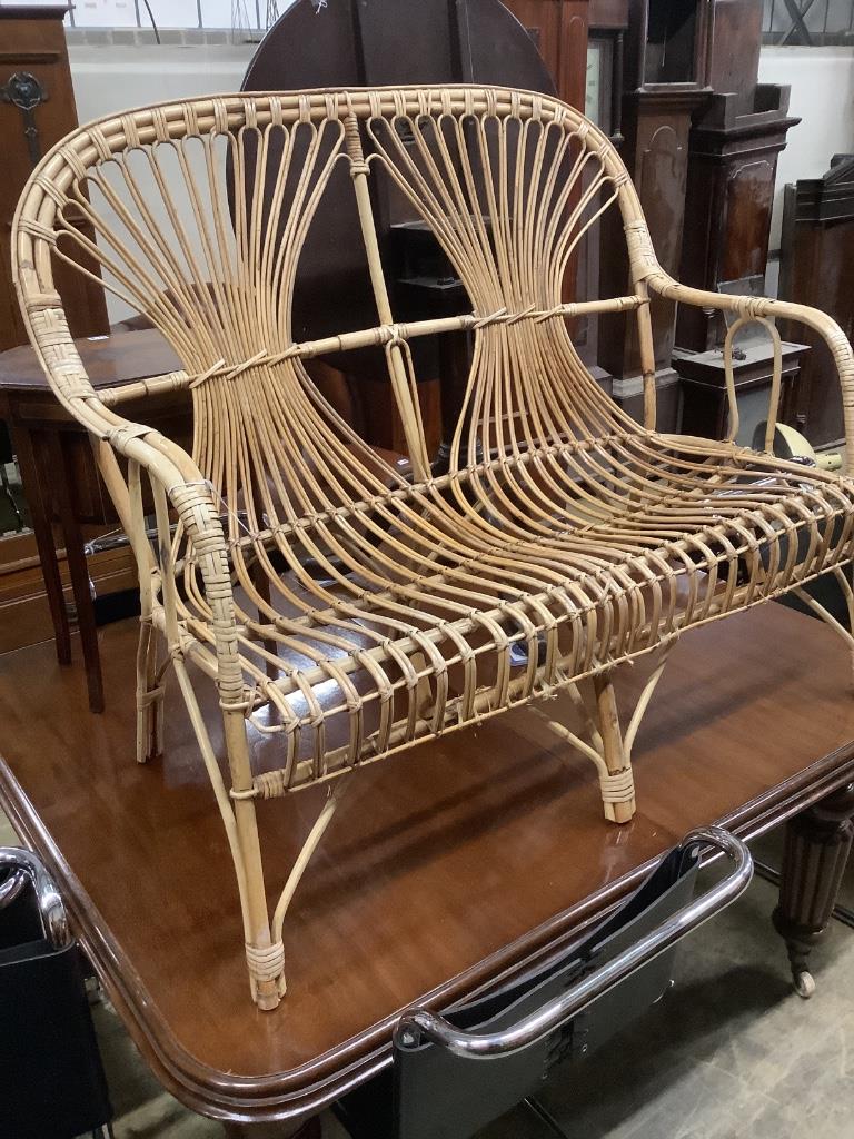 A 1970's bamboo and cane two seater conservatory settee, length 110cm, depth 52cm, height 97cm